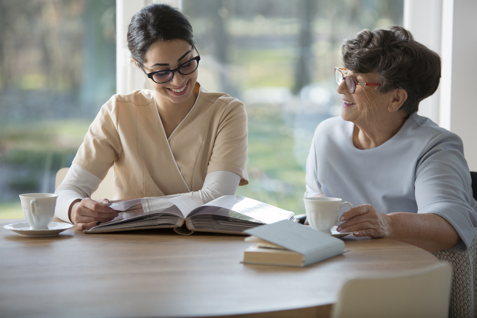 A senior and a caregiver sitting together. 